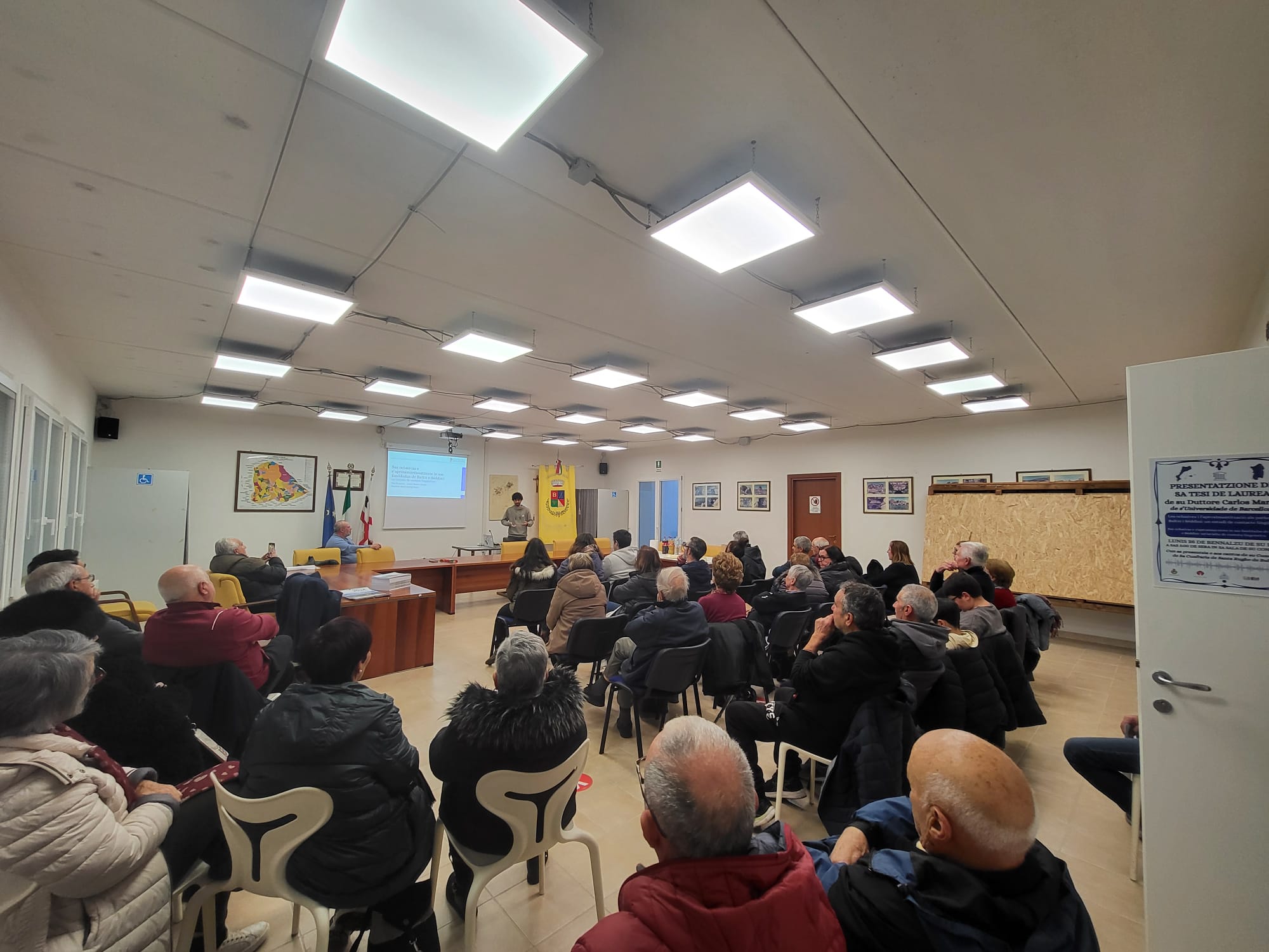 Els assistents a l'acte escolten la presentació